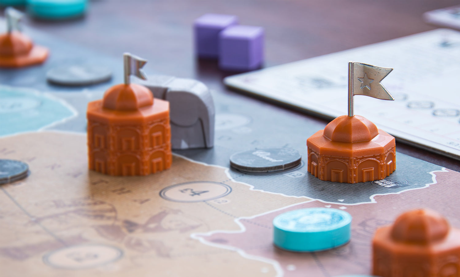 Board game pieces on the map of India.