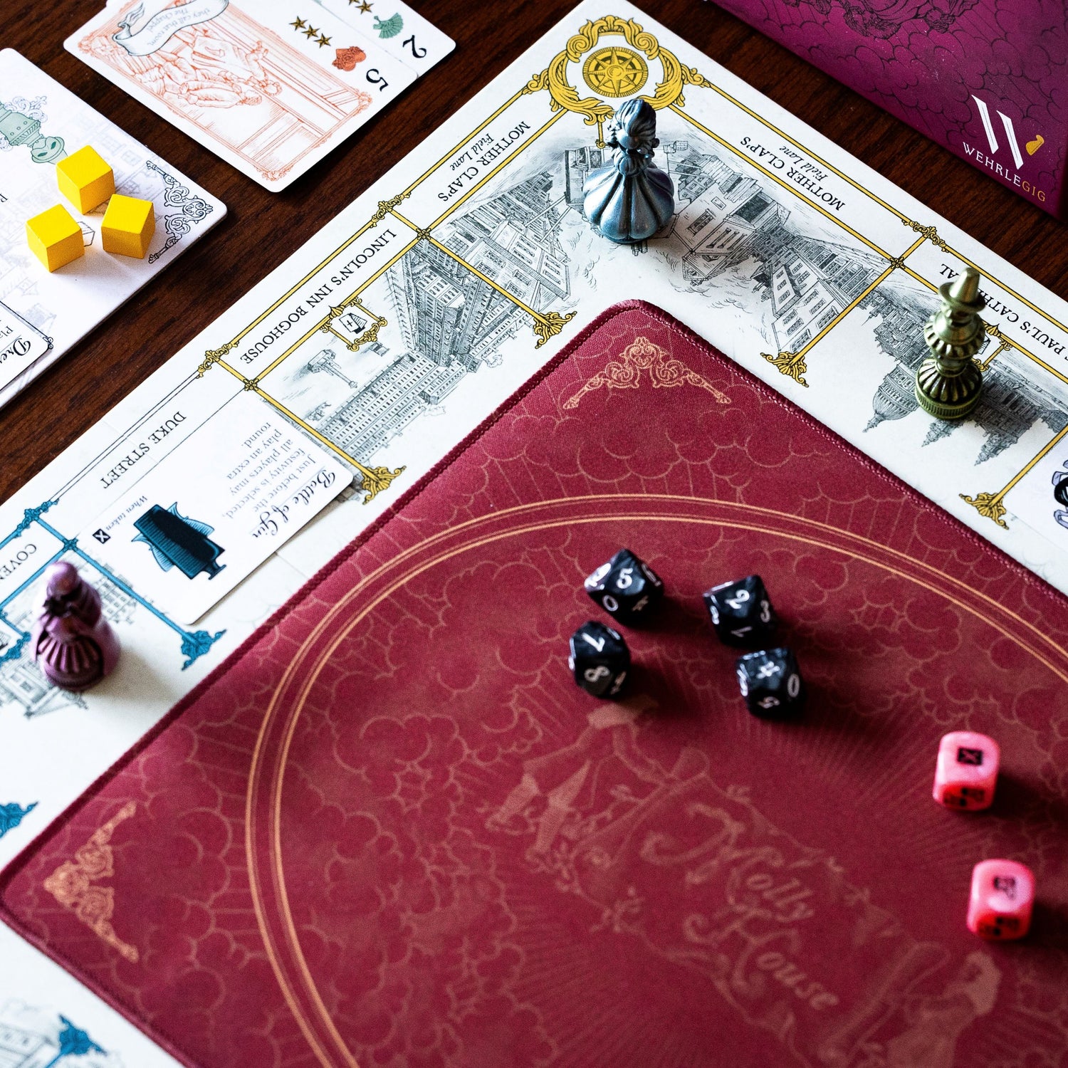 The board in Molly House, roll the pink dice and walk the streets of London with your metal player pawn!
