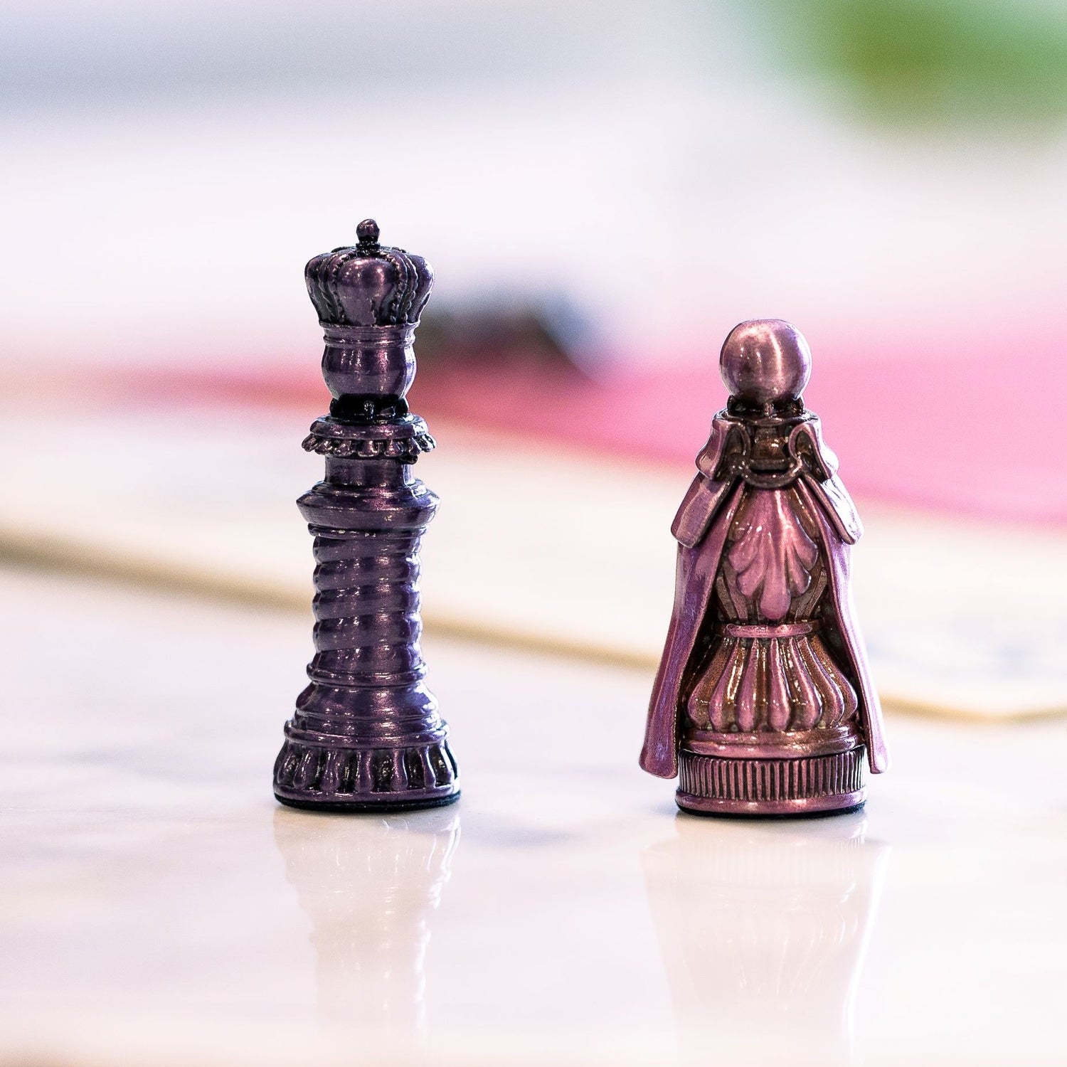 Two of the five metal pawns used for Molly House