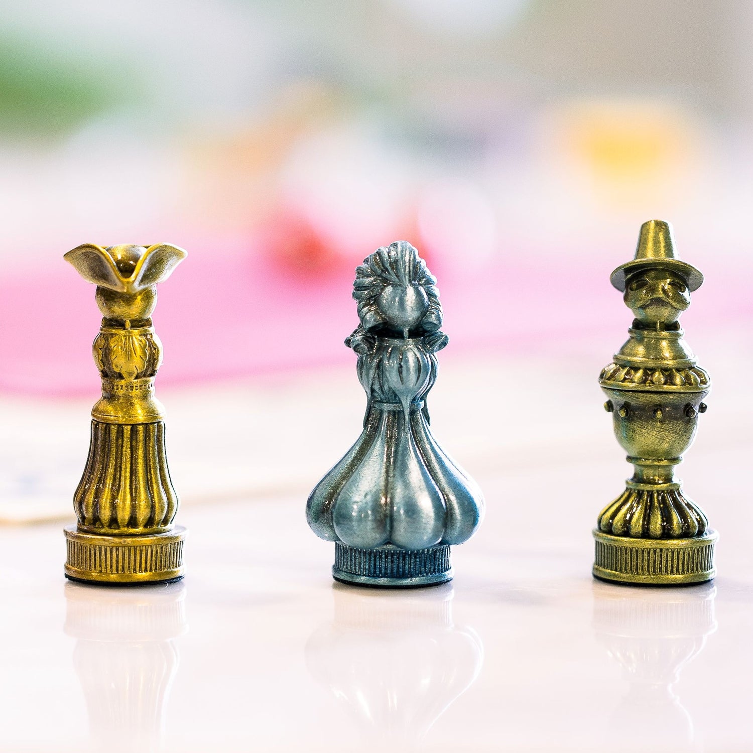 Three of the five metal pawns used for Molly House