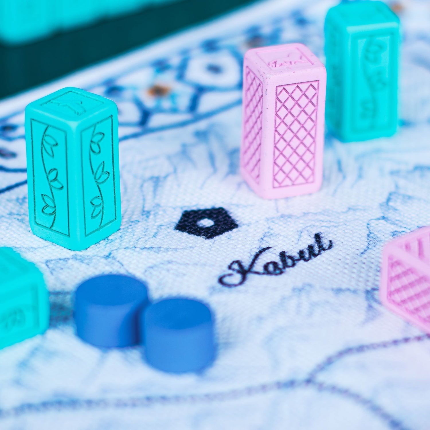 Close up of the cloth map and coalition blocks used in Pax Pamir, a cutthroat strategy game.