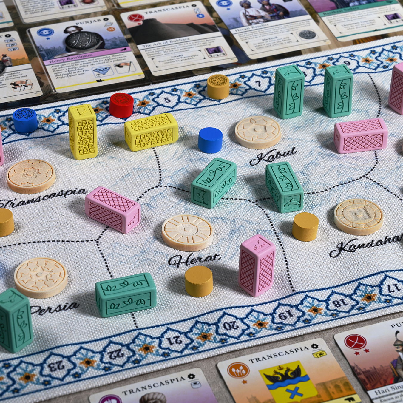 Cloth map of Pax Pamir: Second Edition shown with Resin dominance blocks and wooden ruler tokens.
