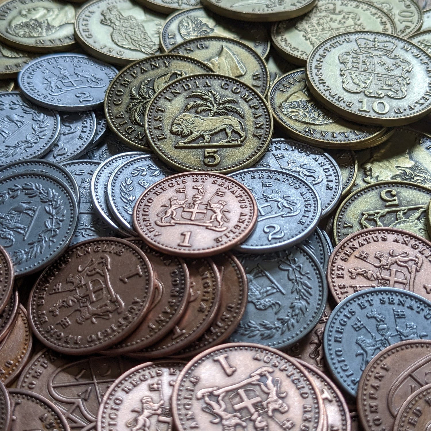 A close-up of the metal coins add-on for John Company: Second Edition